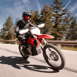 A man rides a motorbike towards the camera.