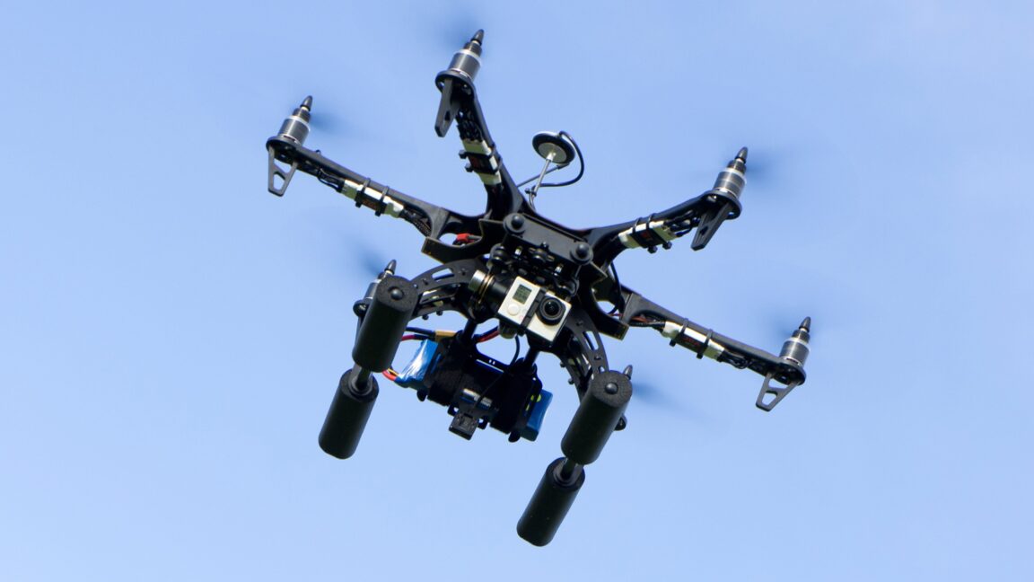 A drone equipped with a camera hovers in the air