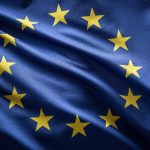 A European Union flag blowing in the wind.