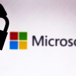 In this photo illustration a padlock appears next to the Microsoft Corporation logo