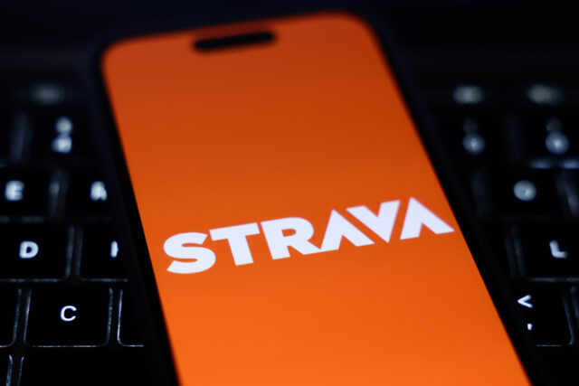 A laptop keyboard and Strava logo displayed on a phone screen are seen in this illustration photo taken in Krakow, Poland on January 15, 2025. (Photo by Jakub Porzycki/NurPhoto via Getty Images)
