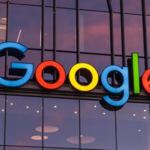 A large Google logo on the outside of a company building.