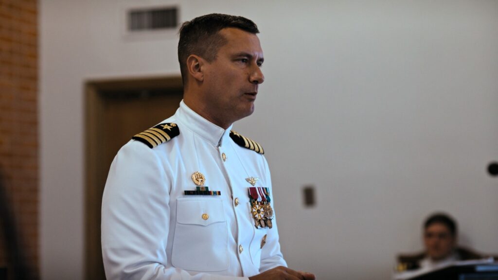 Capt. Kuch presents the successful students with their golden wings.