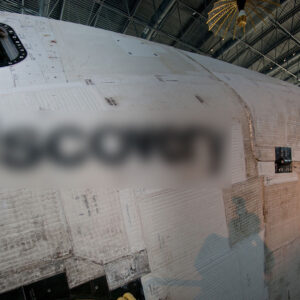 a side view of a space shuttle orbiter with its name digitally blurred out