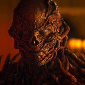 closeup of Vecna in full monster form bathed in ominous red /orange light