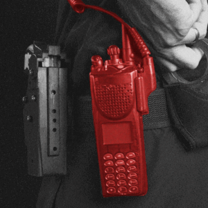 Photo illustration of a red-colored radio attached to a police officer's belt.